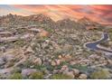 Beautiful aerial view of desert homes integrated into a rocky terrain, enhanced by majestic rock formations at 10671 E Hedgehog Pl, Scottsdale, AZ 85262