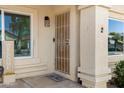 Inviting front entrance featuring a security screen door, manicured landscaping, and great natural light at 1120 N Val Vista Dr # 2, Gilbert, AZ 85234