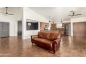 Spacious living room features high ceilings, tile flooring, and an open concept design with access to the kitchen at 12506 W Dreyfus Dr, El Mirage, AZ 85335