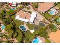 Aerial view of a single-Gathering home featuring a pool, playground, and lush landscaping at 12755 N 99Th Pl, Scottsdale, AZ 85260