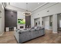 Bright living room boasts hardwood floors, fireplace, modern lighting and comfortable seating at 12755 N 99Th Pl, Scottsdale, AZ 85260