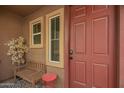 Inviting front porch with bench and table, leading to the entrance door at 1322 S 121St Ln, Avondale, AZ 85323
