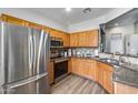 Well-equipped kitchen featuring stainless steel appliances, wooden cabinets, and granite countertops at 14333 W Lexington Ave, Goodyear, AZ 85395