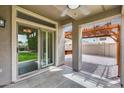 Covered patio with brick flooring, ceiling fan, and views of the backyard and wooden pergola at 14333 W Lexington Ave, Goodyear, AZ 85395