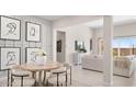 Stylish dining room with modern art, a round table, and seating for six at 15362 W Cottontail Ln, Surprise, AZ 85387