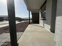 View from the covered front porch showcasing the column, window and desert landscaping at 15748 W Beryl Ave, Waddell, AZ 85355