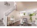 Open-concept living area with stairs, wood floors, neutral decor, and a view into the adjacent dining area at 1623 W Quick Draw Way, San Tan Valley, AZ 85144