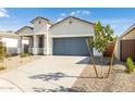 Inviting single-story home with a well-manicured front yard, neutral stucco, and a gray garage door at 17813 W Mission Ln, Waddell, AZ 85355