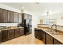 Well-equipped kitchen features dark wood cabinets, granite countertops, and stainless steel appliances at 1821 W Vermont Ave, Phoenix, AZ 85015