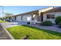 Landscaped single-story home with well-kept lawn, two-car garage, and decorative stone pillars at entry at 2662 S Springwood Blvd # 467, Mesa, AZ 85209