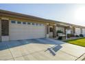 Attractive single-story home with a two-car garage, well-maintained lawn, and a cozy front entryway at 2662 S Springwood Blvd # 467, Mesa, AZ 85209