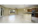 Open-concept living area with tile floors, natural light, ceiling fan, and seamless access to kitchen at 2662 S Springwood Blvd # 467, Mesa, AZ 85209