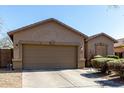 Single-story home with attached garage and a well-maintained front yard at 273 S 152Nd Ave, Goodyear, AZ 85338