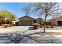 Charming single-story home with a two-car garage and a well-manicured front yard at 273 S 152Nd Ave, Goodyear, AZ 85338