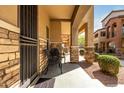 Cozy covered front porch with seating and stylish stone detailing at 2821 S Skyline Dr # 107, Mesa, AZ 85212
