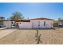 Charming single-story home with a covered carport and low-maintenance desert landscaping at 3009 N 81St Ln, Phoenix, AZ 85033