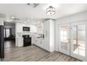 Modern kitchen with white cabinetry, stainless steel appliances, and ample counter space at 3009 N 81St Ln, Phoenix, AZ 85033