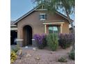 Inviting single-story home with brick and stone accents and desert landscaping at 3816 E Rakestraw Ln, Gilbert, AZ 85298