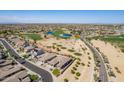 This aerial view displays the neighborhood, golf course, mature trees, and sparkling water at 3948 E Vallejo Dr, Gilbert, AZ 85298