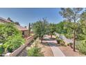 Private backyard with mature trees, walkway, and block wall at 4235 W Harrison St, Chandler, AZ 85226