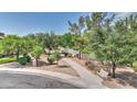 Inviting walking path lined with trees, leading to a scenic community area with a bench for relaxing and enjoying the view at 4235 W Harrison St, Chandler, AZ 85226