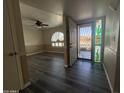 Spacious living room with new dark hardwood floors, custom paint, ceiling fan and stylish cactus-themed stained-glass window at 4615 E Emerald Ave, Mesa, AZ 85206