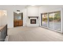 Inviting living area featuring a fireplace, wet bar, and sliding glass doors to outdoor space at 6597 N 79Th Pl, Scottsdale, AZ 85250