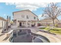Large backyard showcasing a sparkling pool, covered patio, and green space for outdoor enjoyment at 7038 W Beverly Rd, Laveen, AZ 85339