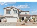 Charming two-story home featuring a two-car garage, desert landscaping, and a welcoming front porch at 7038 W Beverly Rd, Laveen, AZ 85339