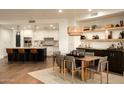 Bright dining area features an elegant woven pendant light and built-in bar with open shelving at 7175 E Camelback Rd # 401, Scottsdale, AZ 85251