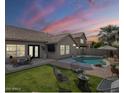 Beautiful backyard featuring a pool, manicured lawn, and outdoor seating area perfect for entertaining at 7252 E Nido Ave, Mesa, AZ 85209