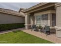 Quaint front patio with chairs, perfect for relaxing and enjoying the beautiful neighborhood views at 7252 E Nido Ave, Mesa, AZ 85209