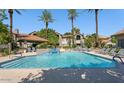 Sparkling pool with palm trees, lounge chairs, and a covered gazebo create a resort-like ambiance at 9600 N 96Th St # 257, Scottsdale, AZ 85258