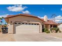 A large two car garage attached to the house provides ample space for parking and storage at 12826 S 40Th Pl, Phoenix, AZ 85044