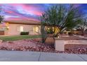 Charming single-story home featuring desert landscaping and stone accents at 13007 W Tuckey Ct, Glendale, AZ 85307
