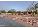 Beautiful single-story home with desert landscaping, rock features, and well-maintained yard at 13007 W Tuckey Ct, Glendale, AZ 85307