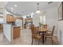 Eat-in kitchen featuring wood cabinets, tile floors, and an island counter at 13545 W Caribbean Ln, Surprise, AZ 85379