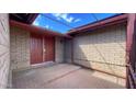 Inviting covered entry featuring a double front door, brick paving, and a brick facade at 13834 N 39Th Ln, Phoenix, AZ 85053