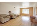 Bright living room featuring hardwood floors, neutral walls, large window, and comfortable seating at 13834 N 39Th Ln, Phoenix, AZ 85053