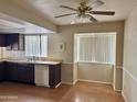 Bright kitchen with wood cabinets, laminate floors, and plenty of natural light at 1512 N Iowa St, Chandler, AZ 85225