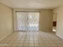 Bright living room featuring neutral walls, tile flooring, and natural light at 1512 N Iowa St, Chandler, AZ 85225