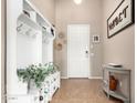 Cozy entryway featuring a decorative console table, coat rack, and earth-tone tile flooring at 22319 E Via De Olivos --, Queen Creek, AZ 85142