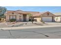 Inviting single-story home with desert landscaping, barrel tile roof and two-car garage at 23106 N 146Th Ln, Sun City West, AZ 85375