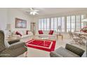 Bright living room features plantation shutters, neutral decor, and a comfortable seating arrangement at 23106 N 146Th Ln, Sun City West, AZ 85375