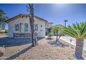 Charming single-story home with low-maintenance desert landscaping and a stone-accented facade at 32241 N Dog Leg Ct, San Tan Valley, AZ 85143