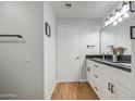 Bathroom featuring double sink vanity with modern lighting and white cabinets at 3302 N 7Th St # 364, Phoenix, AZ 85014