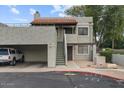 Two-story condo with covered parking, private entry, red tile roof, neutral stucco, and lush landscaping at 3309 N 70Th St # 108, Scottsdale, AZ 85251