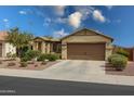 Lovely home with a neatly manicured front yard, a covered porch, and an attached two-car garage at 3519 S 185Th Dr, Goodyear, AZ 85338