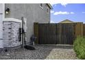 Backyard gate leading to side yard with utility access at 40481 W Desert Fairways Dr, Maricopa, AZ 85138