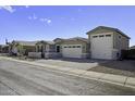 Charming single-story home featuring a three-car garage and paver driveway at 40481 W Desert Fairways Dr, Maricopa, AZ 85138